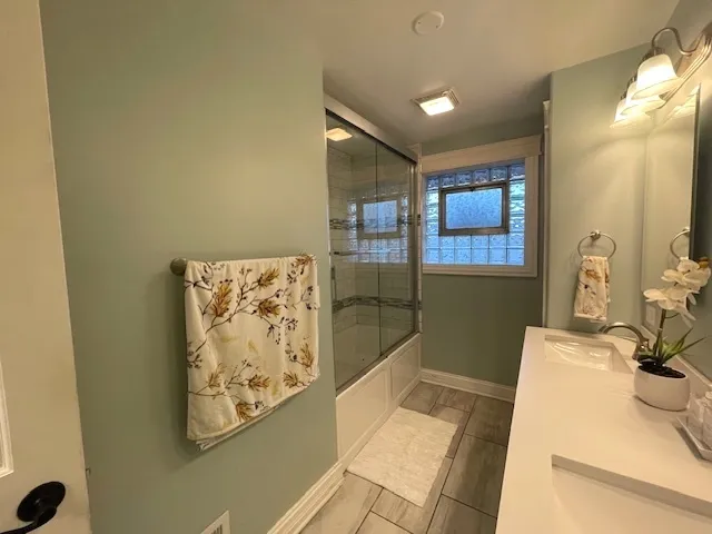 a bathroom with a bathtub and shower