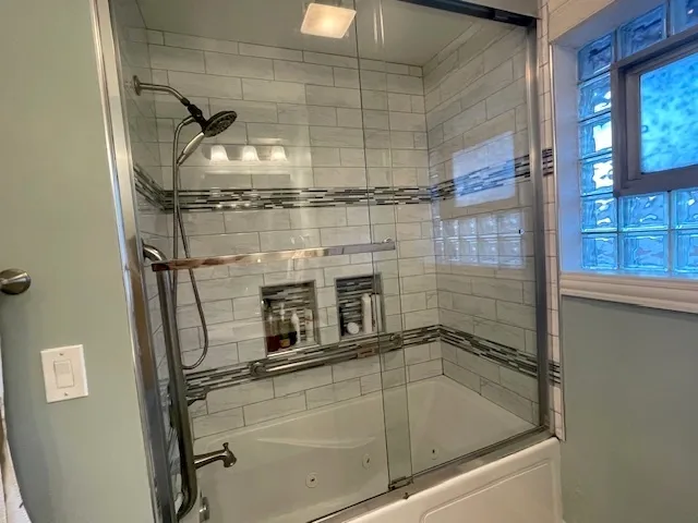 a bathroom with a shower and mirror