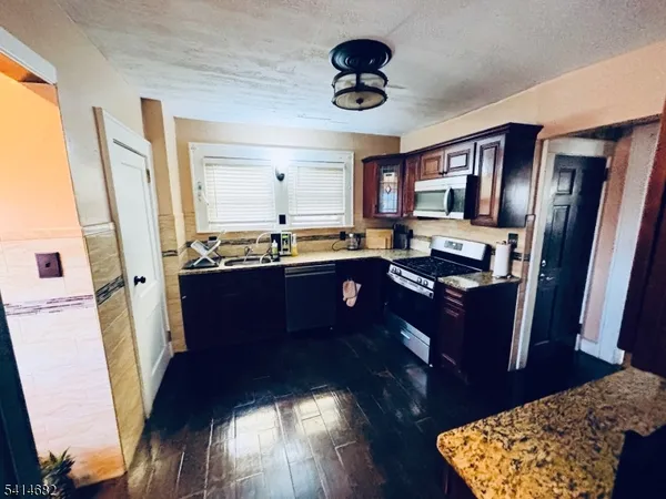 a living room with hard wood floors and a wooden floor
