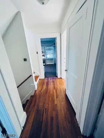a bedroom with bed couch and window
