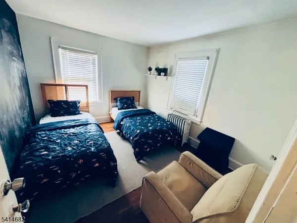 a bedroom with bed and a window