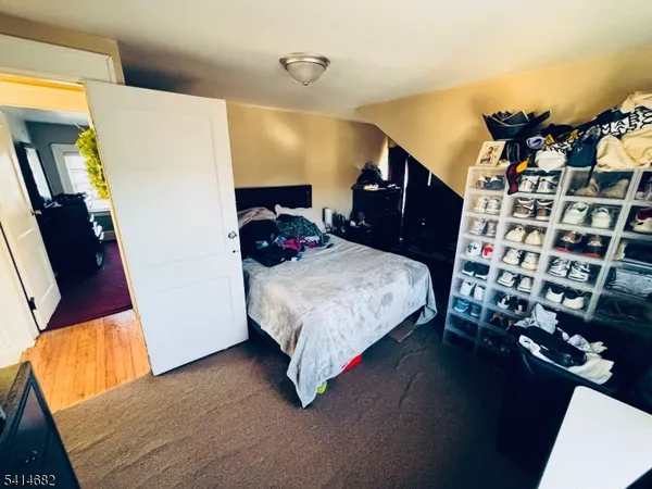 a bedroom with bed and a dresser