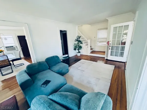 a living room with furniture and potted plants