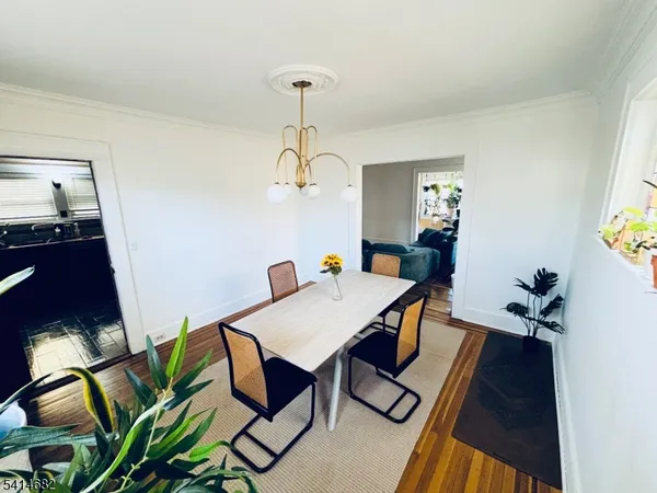 a view of a dining room with furniture wooden floor and chandelier