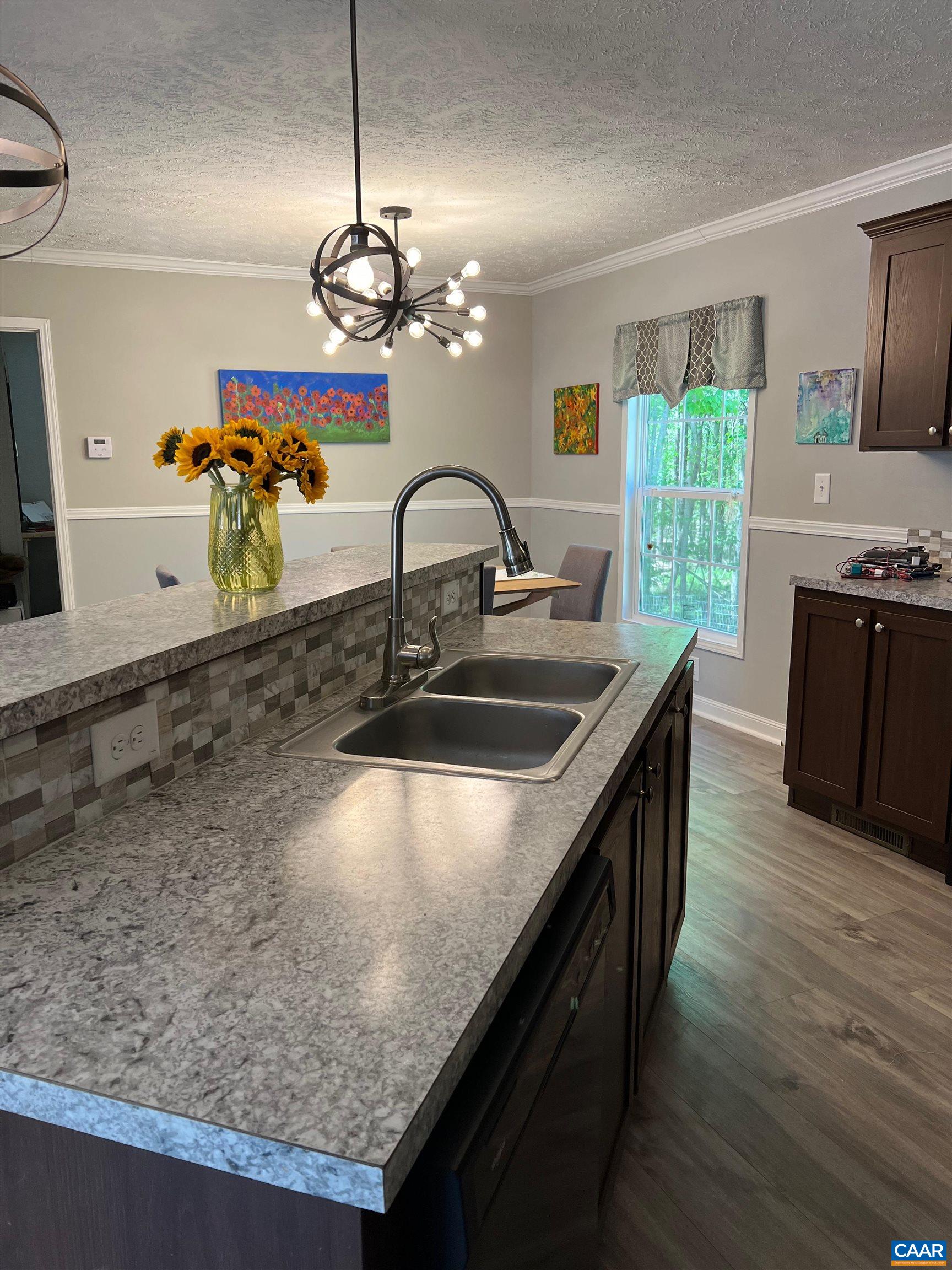 1261 Miles Jackson Road Palmyra, VA 22963 - Photo 12 of 40 a kitchen with stainless steel appliances granite countertop a sink a stove and a wooden floors