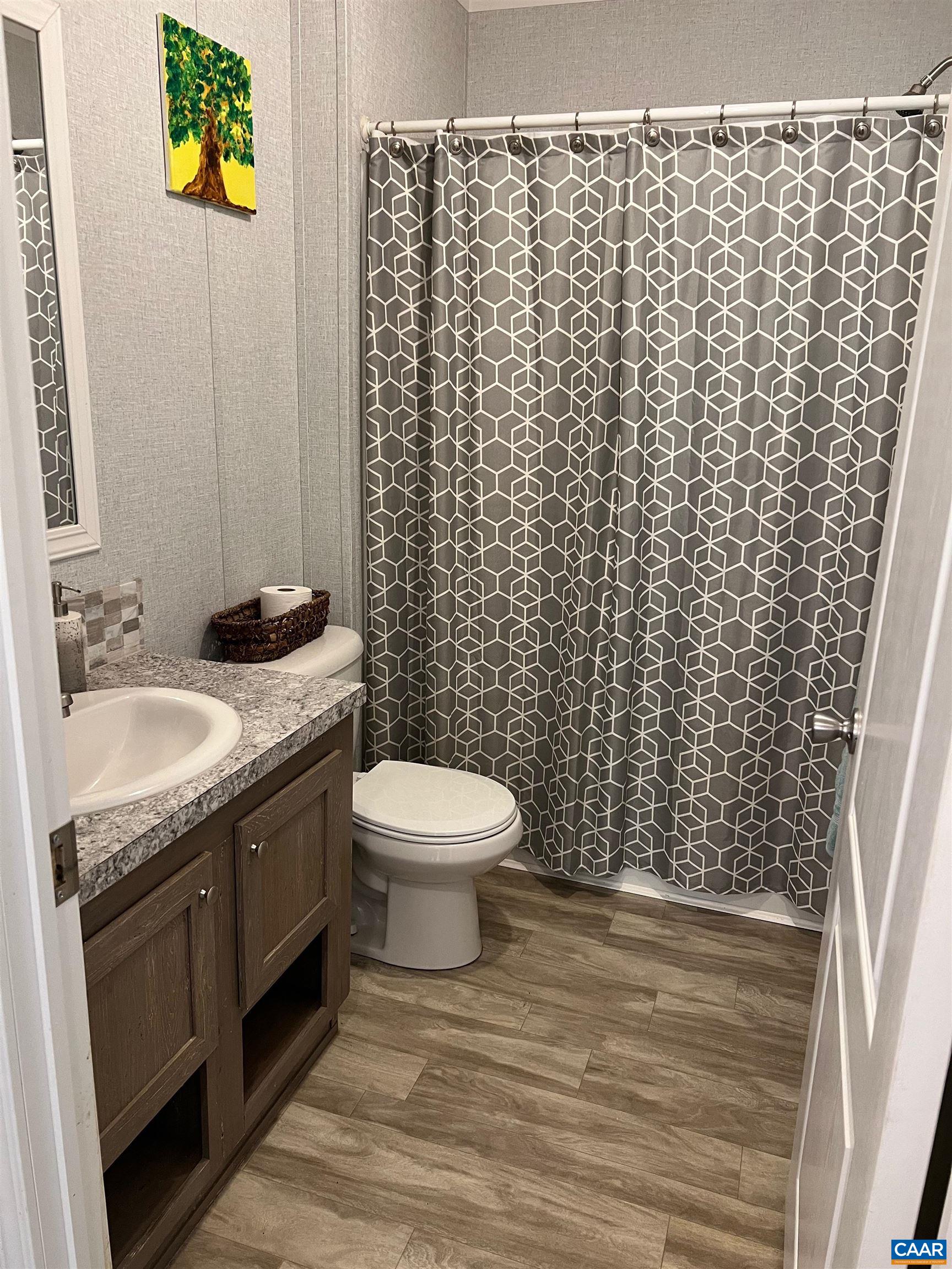1261 Miles Jackson Road Palmyra, VA 22963 - Photo 20 of 40 a bathroom with a granite countertop toilet and a sink