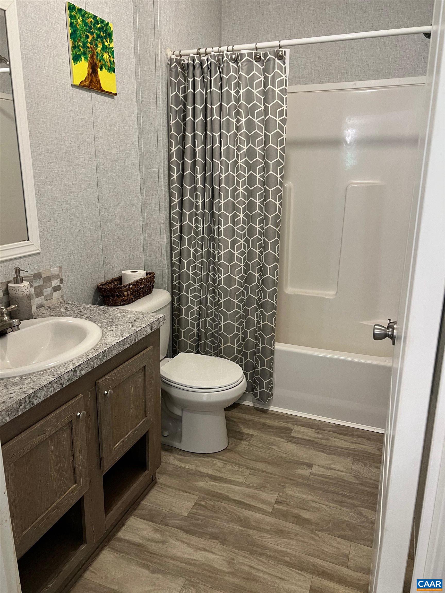 1261 Miles Jackson Road Palmyra, VA 22963 - Photo 21 of 40 a bathroom with a granite countertop sink toilet and shower