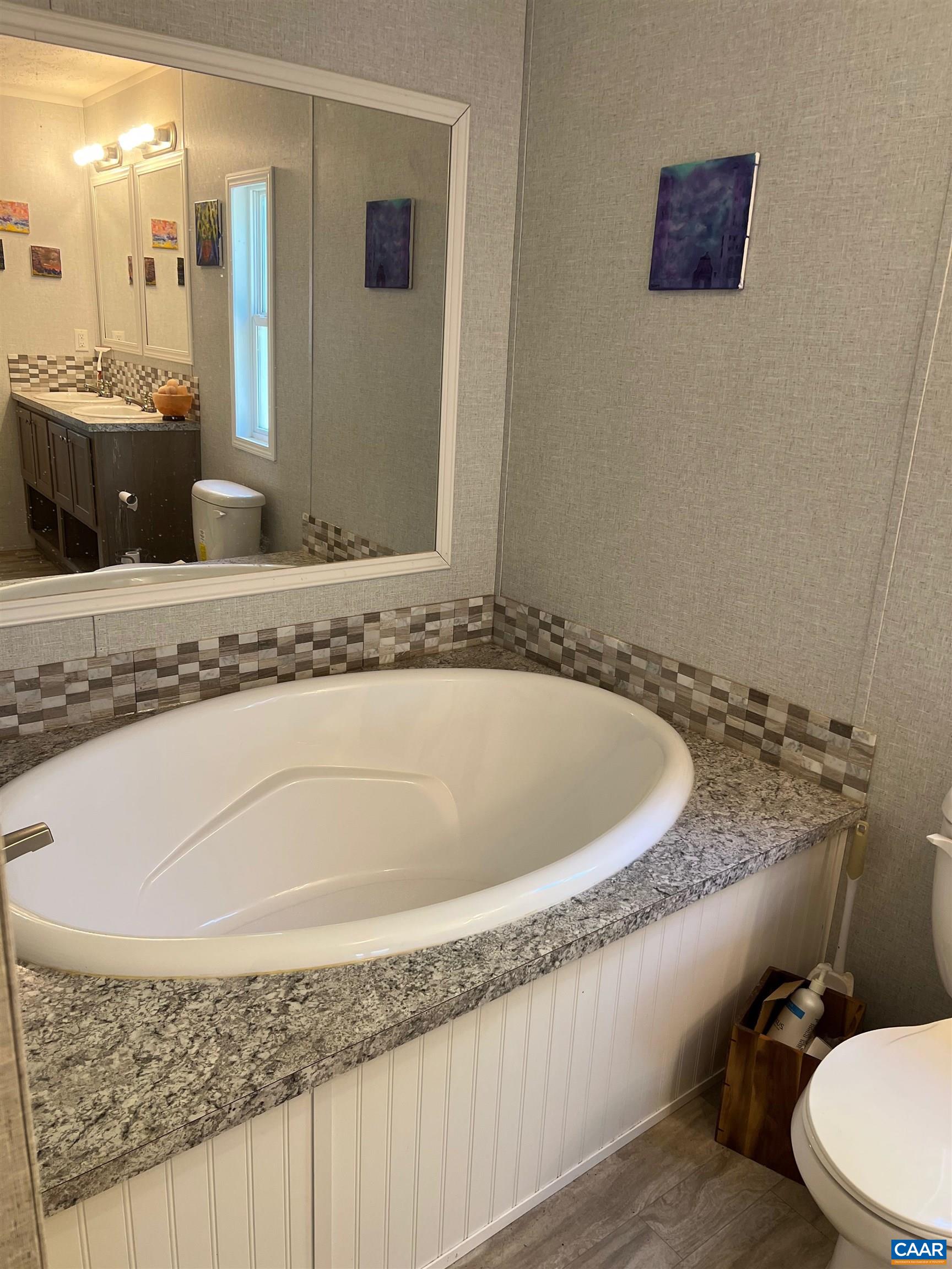 1261 Miles Jackson Road Palmyra, VA 22963 - Photo 25 of 40 a bathroom with a granite countertop sink and a mirror