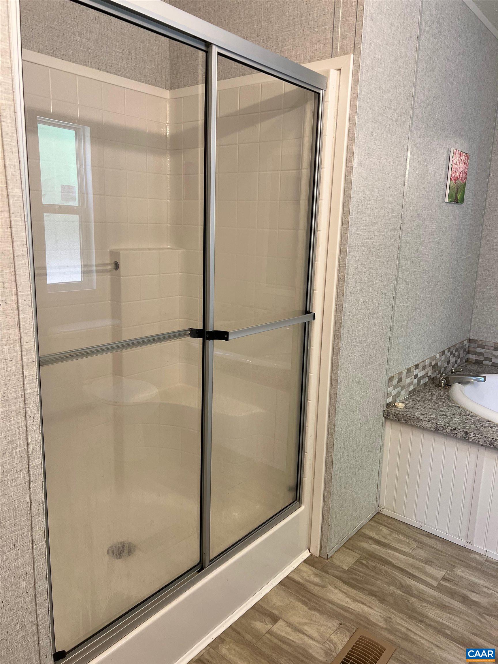 1261 Miles Jackson Road Palmyra, VA 22963 - Photo 27 of 40 a bathroom with a granite countertop shower and a sink