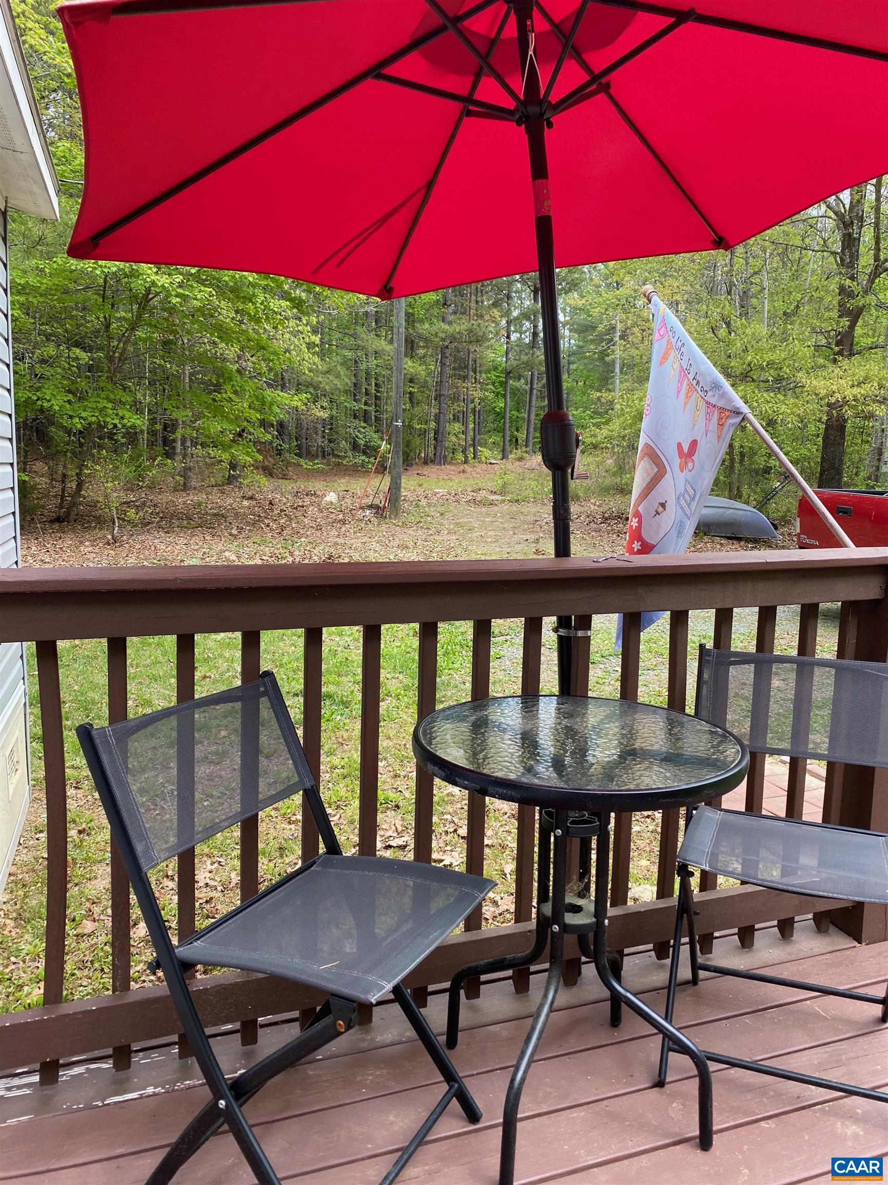 1261 Miles Jackson Road Palmyra, VA 22963 - Photo 4 of 40 a view of a patio with table and chairs under an umbrella