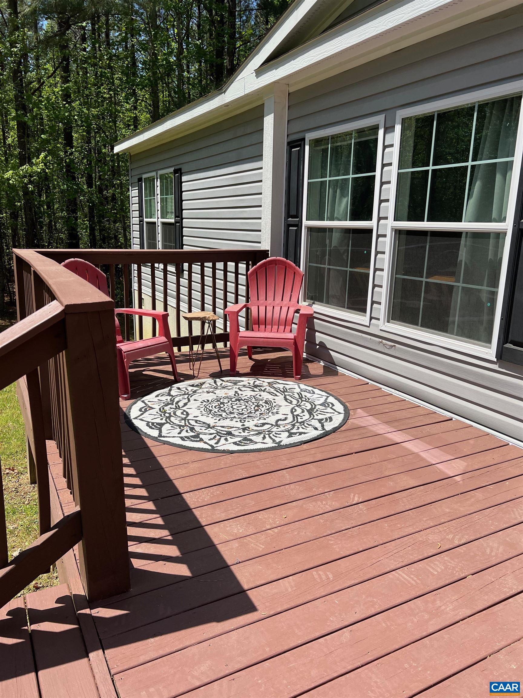 1261 Miles Jackson Road Palmyra, VA 22963 - Photo 5 of 40 a view of a deck with couches floor to ceiling window with wooden floor
