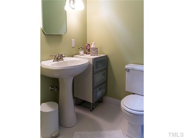 2811 Barmettler Street Raleigh, NC 27607 - Photo 12 of 22 a bathroom with a sink a toilet and mirror