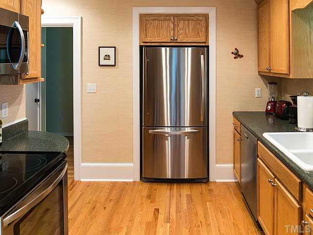 2811 Barmettler Street Raleigh, NC 27607 - Photo 2 of 22 a kitchen with granite countertop a refrigerator and a sink
