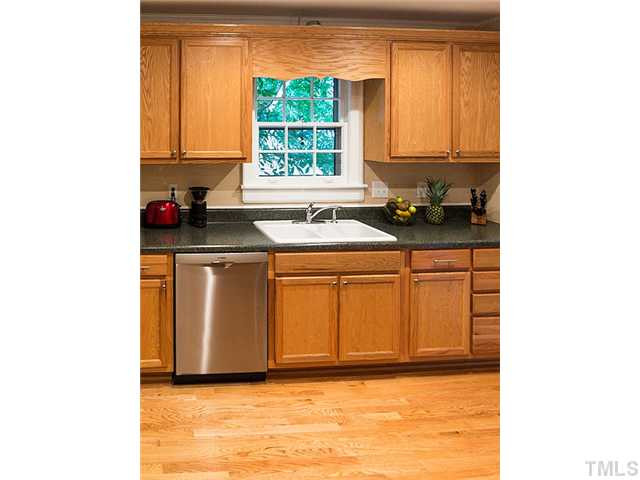 2811 Barmettler Street Raleigh, NC 27607 - Photo 3 of 22 a kitchen with a sink cabinets and window