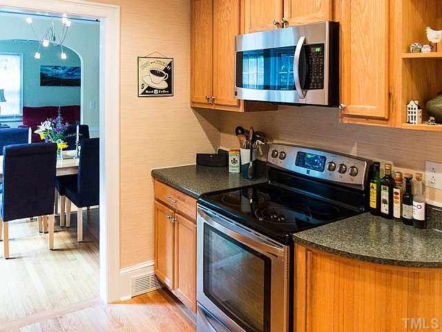 2811 Barmettler Street Raleigh, NC 27607 - Photo 4 of 22 a kitchen with stainless steel appliances granite countertop a stove and a sink