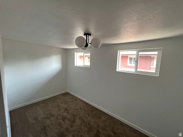 545 23rd Street Ogden, UT 84401 - Photo 12 of 28 Room featuring light gray walls, white baseboards, and brown carpet flooring