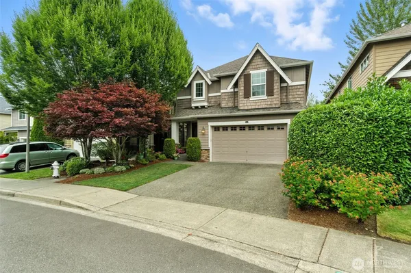 a front view of a house with a yard and garage