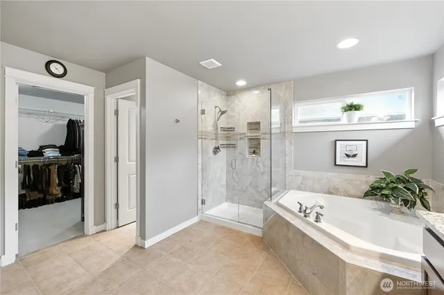 a bathroom with a bathtub and a shower