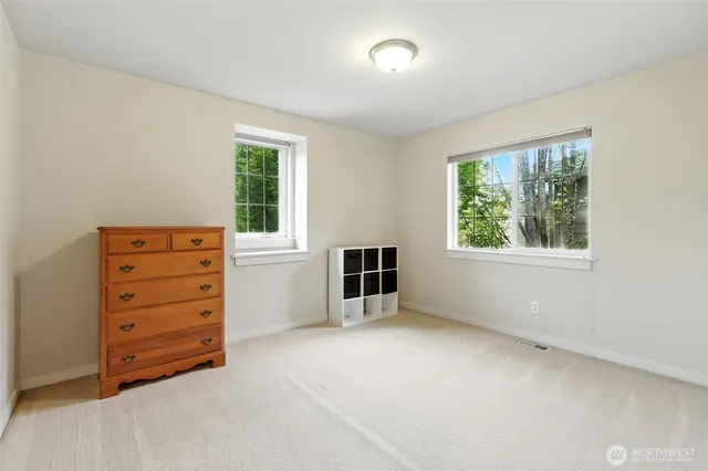 an empty room with furniture and a window