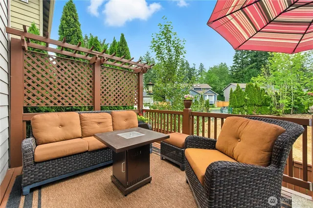 a view of a patio with table and chairs potted plants with wooden fence