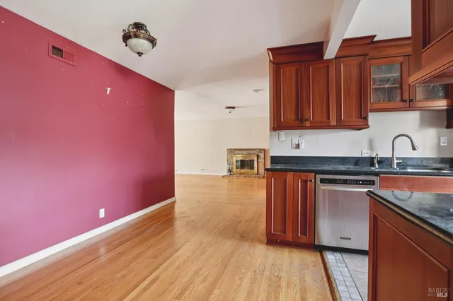 a kitchen with granite countertop a stove and cabinets