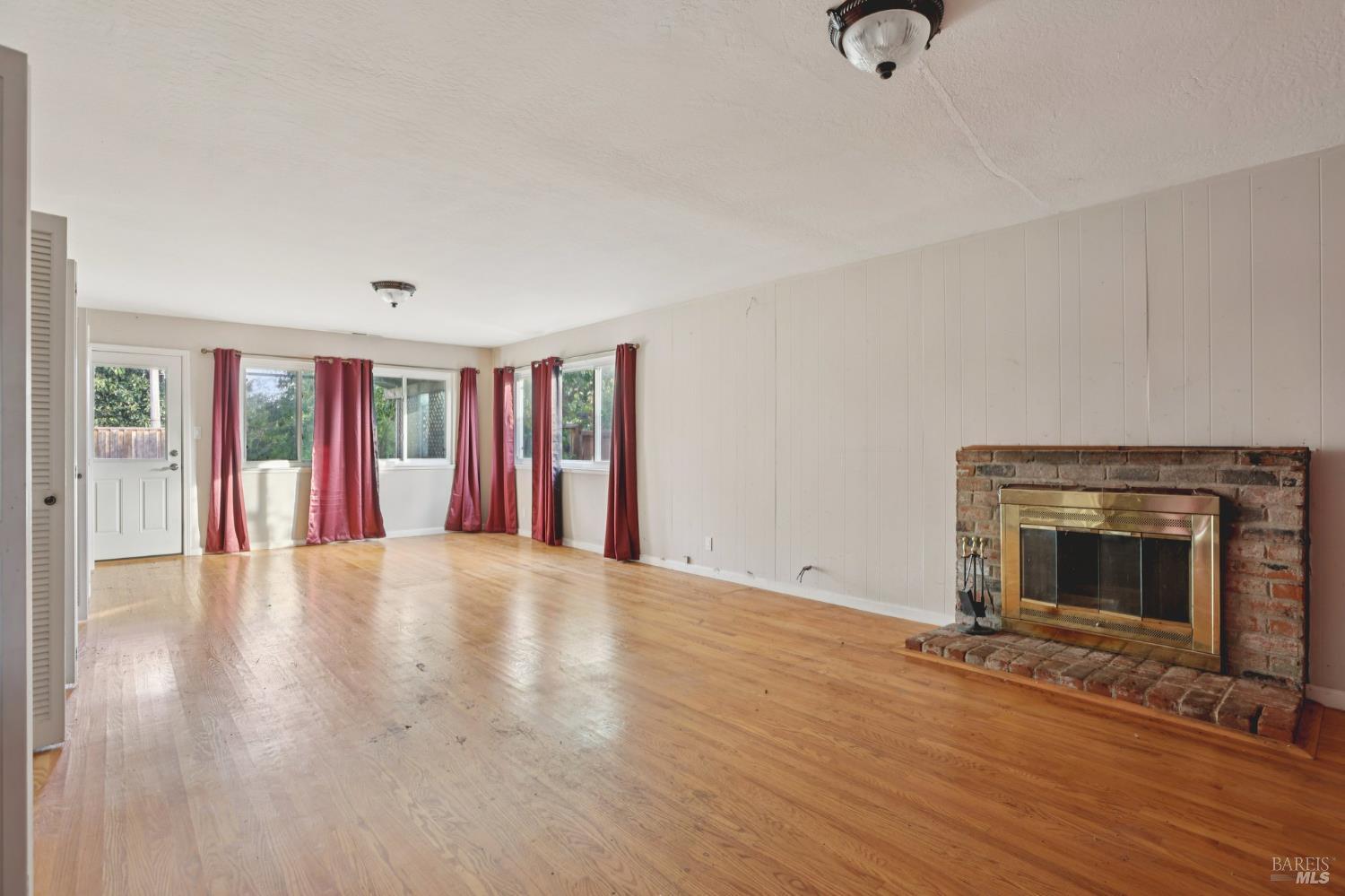 1023 Avondale Lane Hayward, CA 94545 - Photo 9 of 24 a view of an empty room with wooden floor and a fireplace