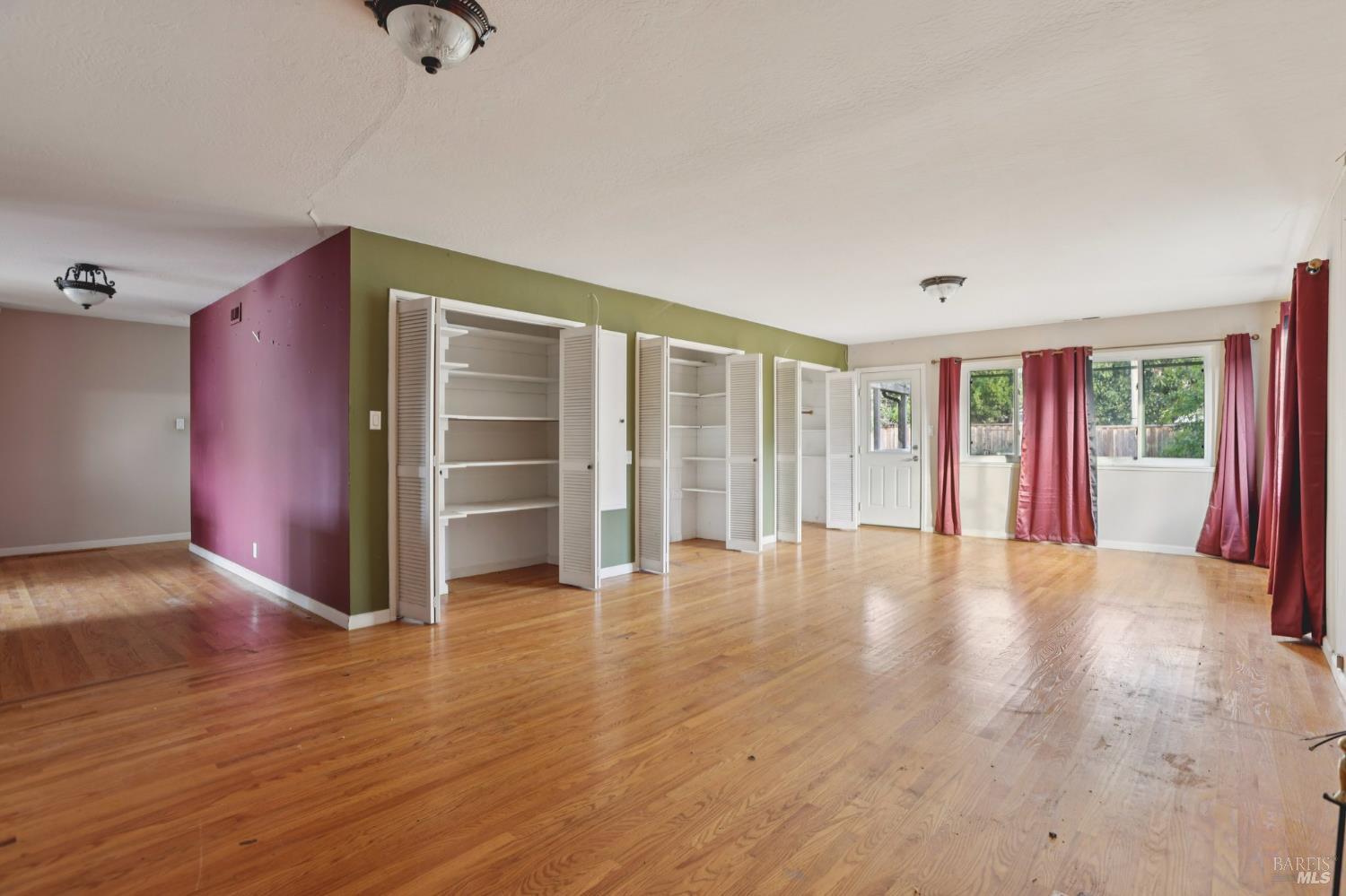 1023 Avondale Lane Hayward, CA 94545 - Photo 10 of 24 a view of an empty room with a window and wooden floor