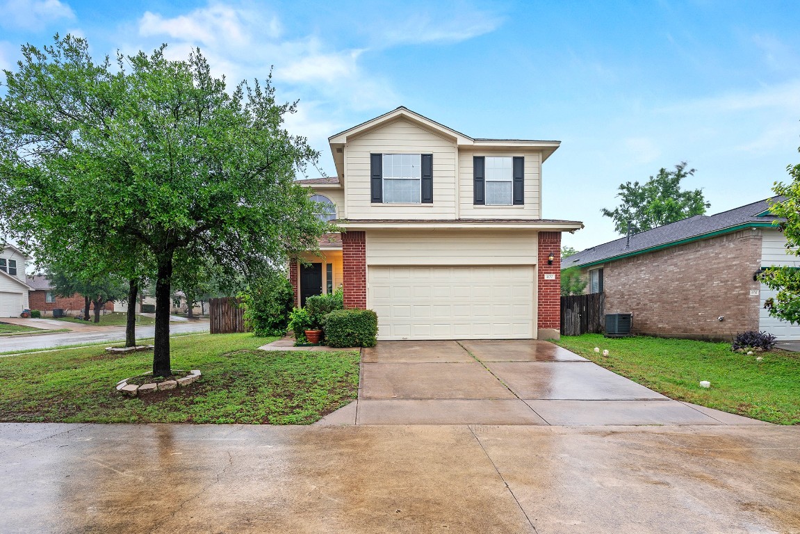 400 Tudor House Road Pflugerville, TX 78660 - Photo 1 of 1 a front view of a house with a yard and garage