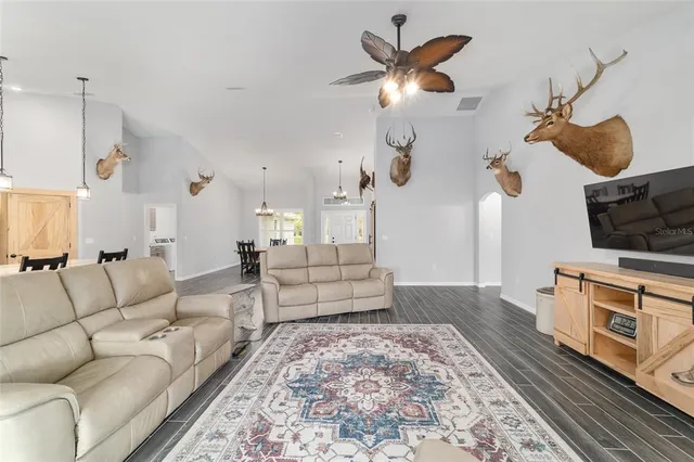 a kitchen with stainless steel appliances granite countertop a sink a stove and a wooden floors