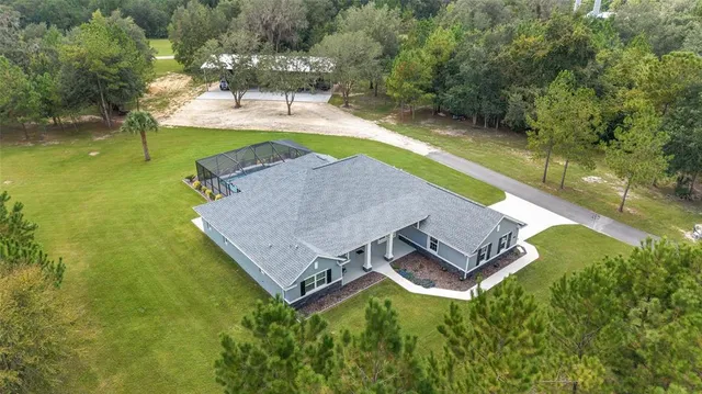 a front view of a house with swimming pool having outdoor seating