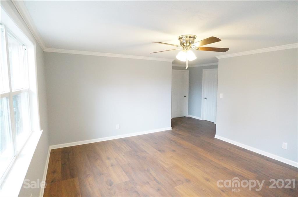 291 9th Avenue Northwest Hickory, NC 28601 - Photo 2 of 7 an empty room with windows and fan