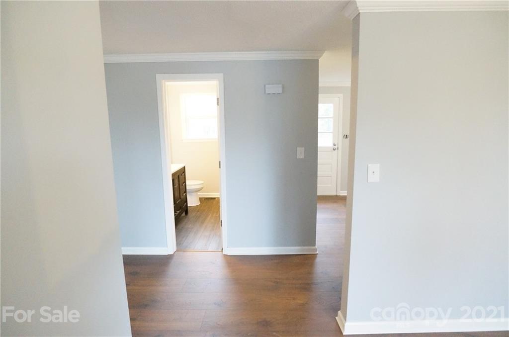 291 9th Avenue Northwest Hickory, NC 28601 - Photo 3 of 7 a view of a hallway with wooden floor and a bathroom