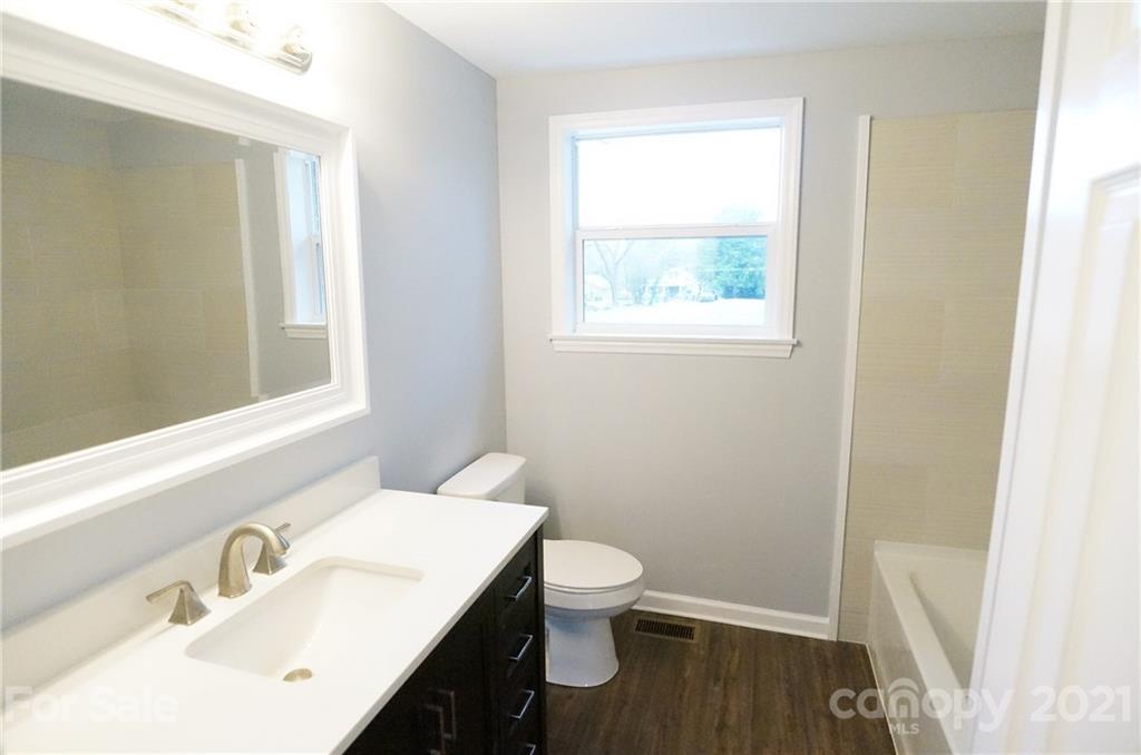 291 9th Avenue Northwest Hickory, NC 28601 - Photo 5 of 7 a bathroom with a sink a toilet and a window
