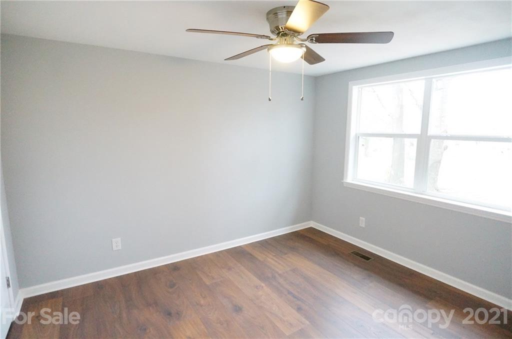 291 9th Avenue Northwest Hickory, NC 28601 - Photo 6 of 7 an empty room with a window and a fan