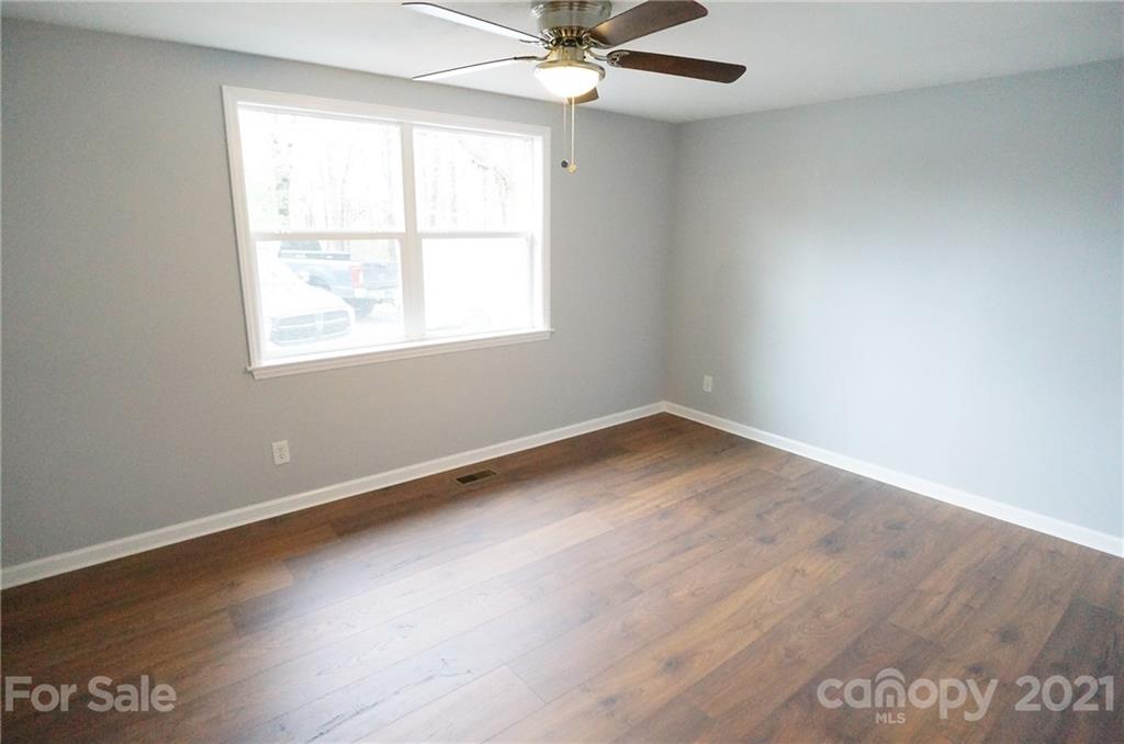 291 9th Avenue Northwest Hickory, NC 28601 - Photo 7 of 7 an empty room with wooden floor fan and windows