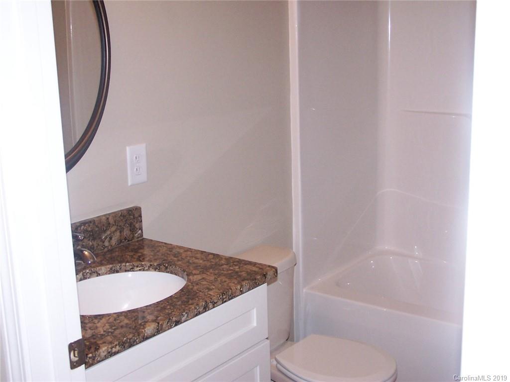 400 Rowan Mill Road Salisbury, NC 28147 - Photo 15 of 24 a bathroom with a granite countertop sink toilet and shower