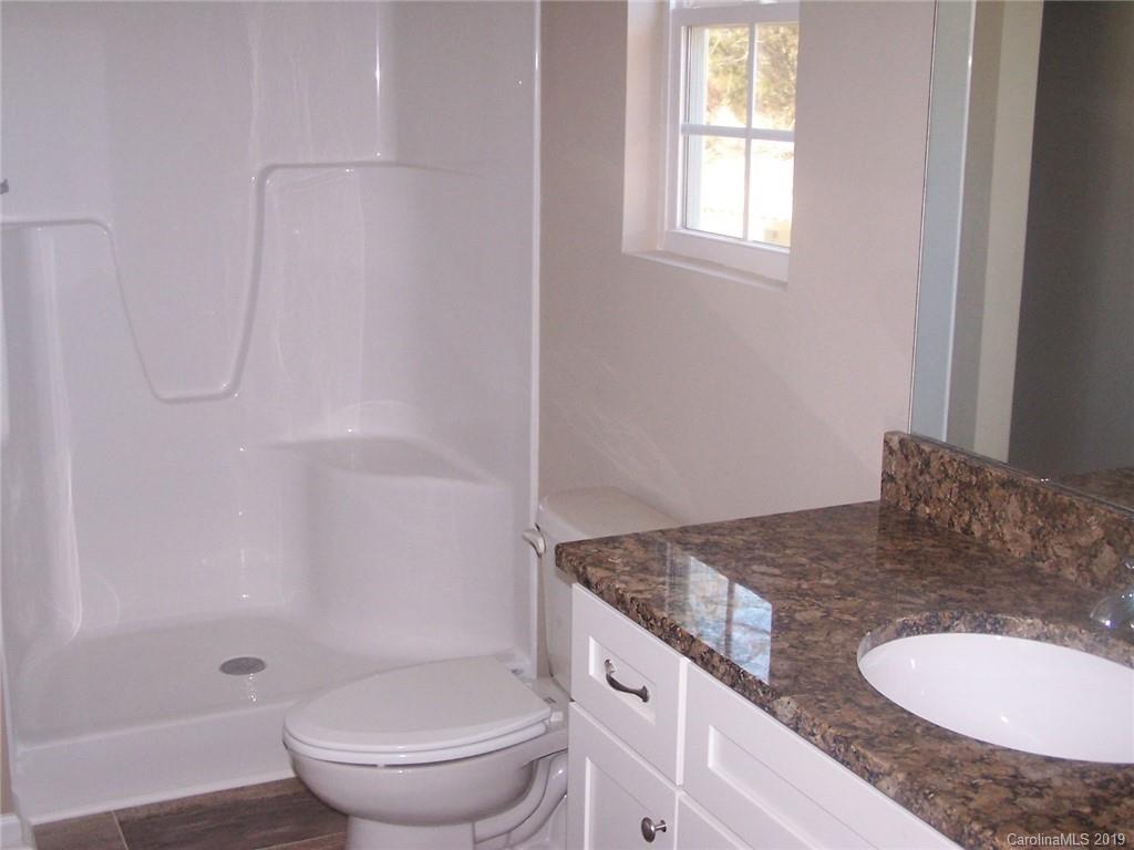 400 Rowan Mill Road Salisbury, NC 28147 - Photo 17 of 24 a bathroom with a granite countertop sink toilet and shower