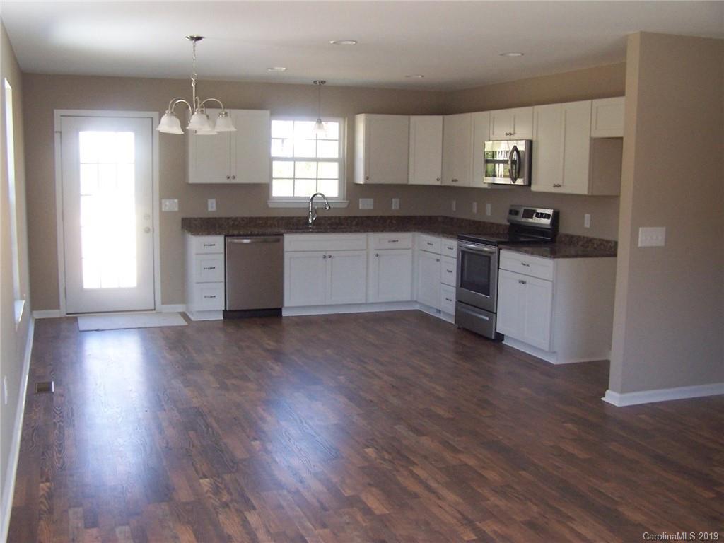 400 Rowan Mill Road Salisbury, NC 28147 - Photo 7 of 24 a kitchen with granite countertop wooden floors stainless steel appliances and window
