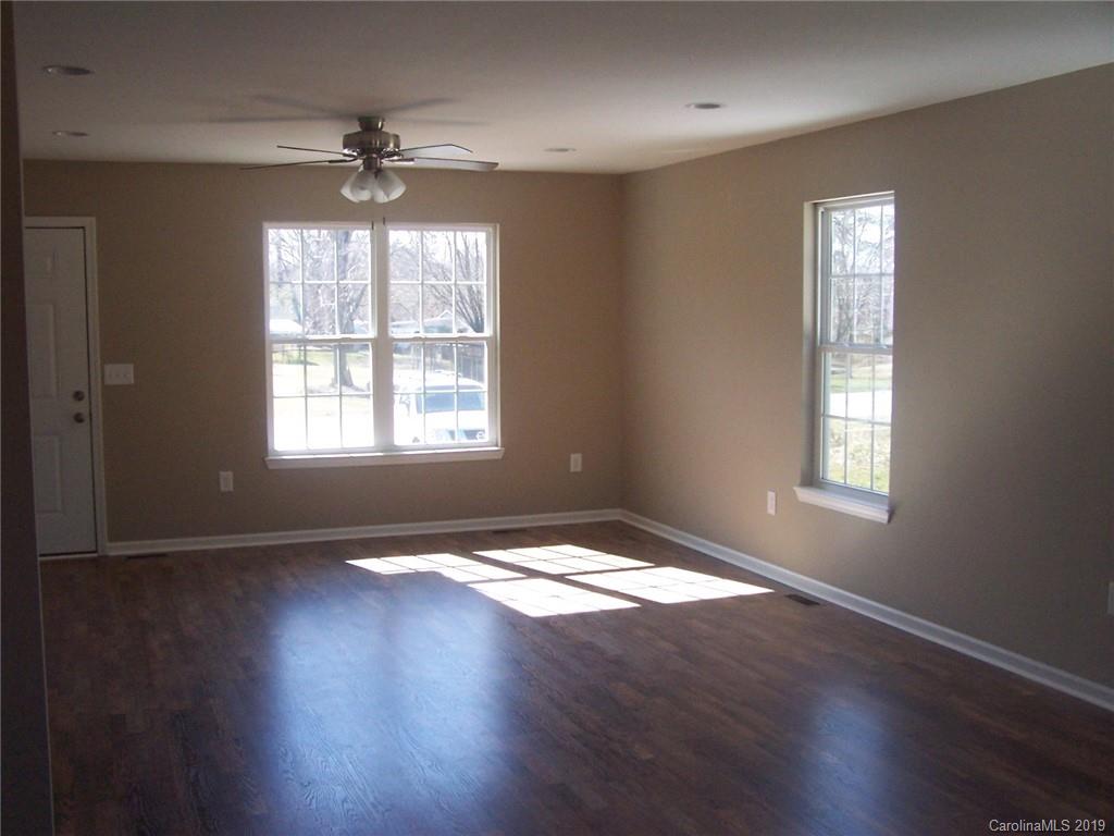 400 Rowan Mill Road Salisbury, NC 28147 - Photo 8 of 24 a view of an empty room with wooden floor and a window