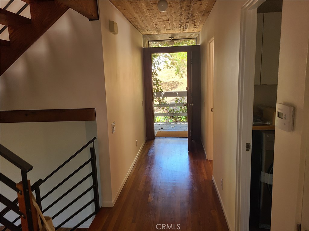 243 Amy Way Topanga, CA 90290 - Photo 14 of 31 a view of a hallway with wooden floor and staircase