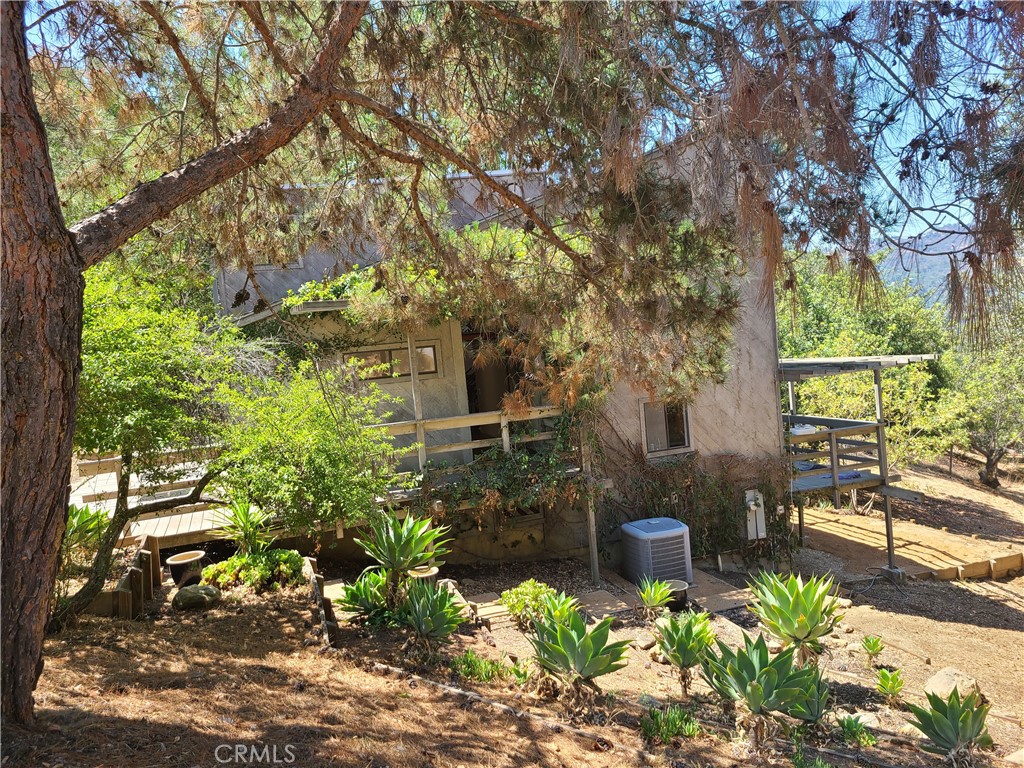 243 Amy Way Topanga, CA 90290 - Photo 21 of 31 a backyard of a house with a garden and outdoor seating