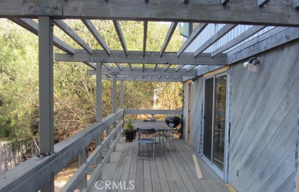 243 Amy Way Topanga, CA 90290 - Photo 23 of 31 a dining room with wooden floor table and chairs