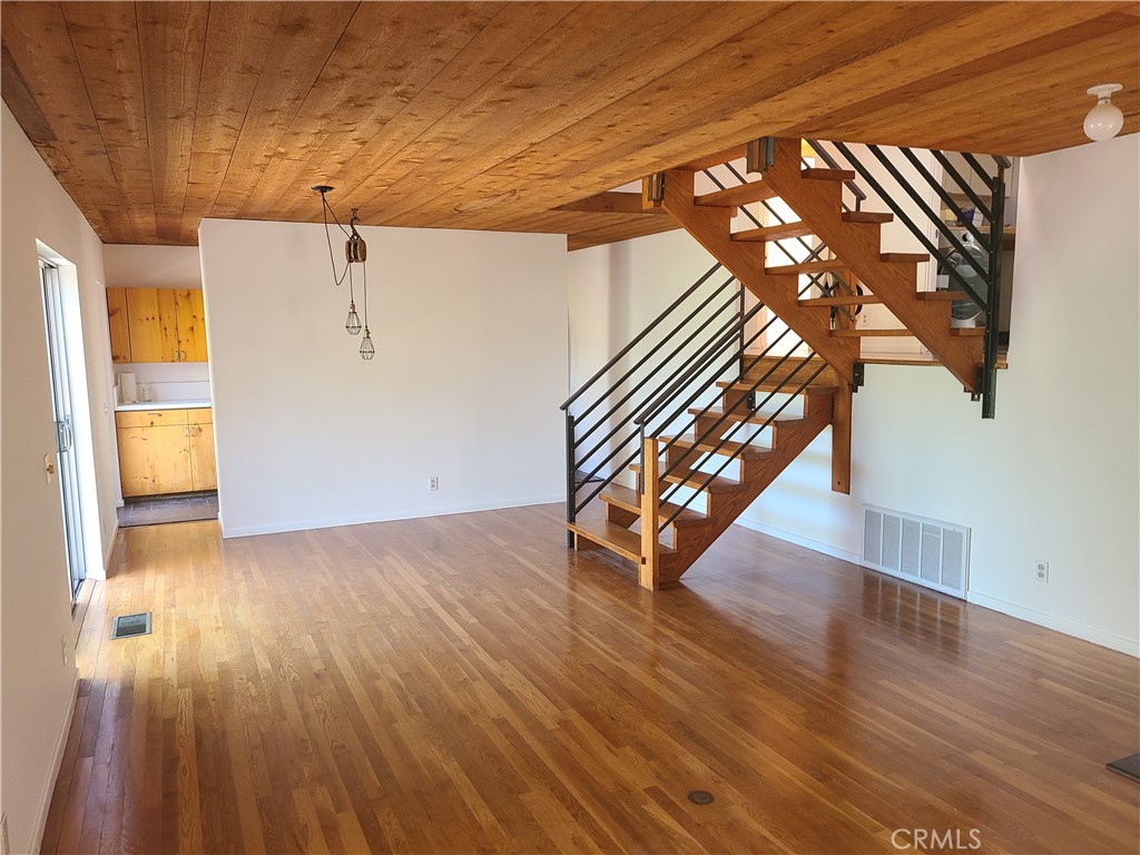 243 Amy Way Topanga, CA 90290 - Photo 7 of 31 a view of an empty room with wooden floor and windows