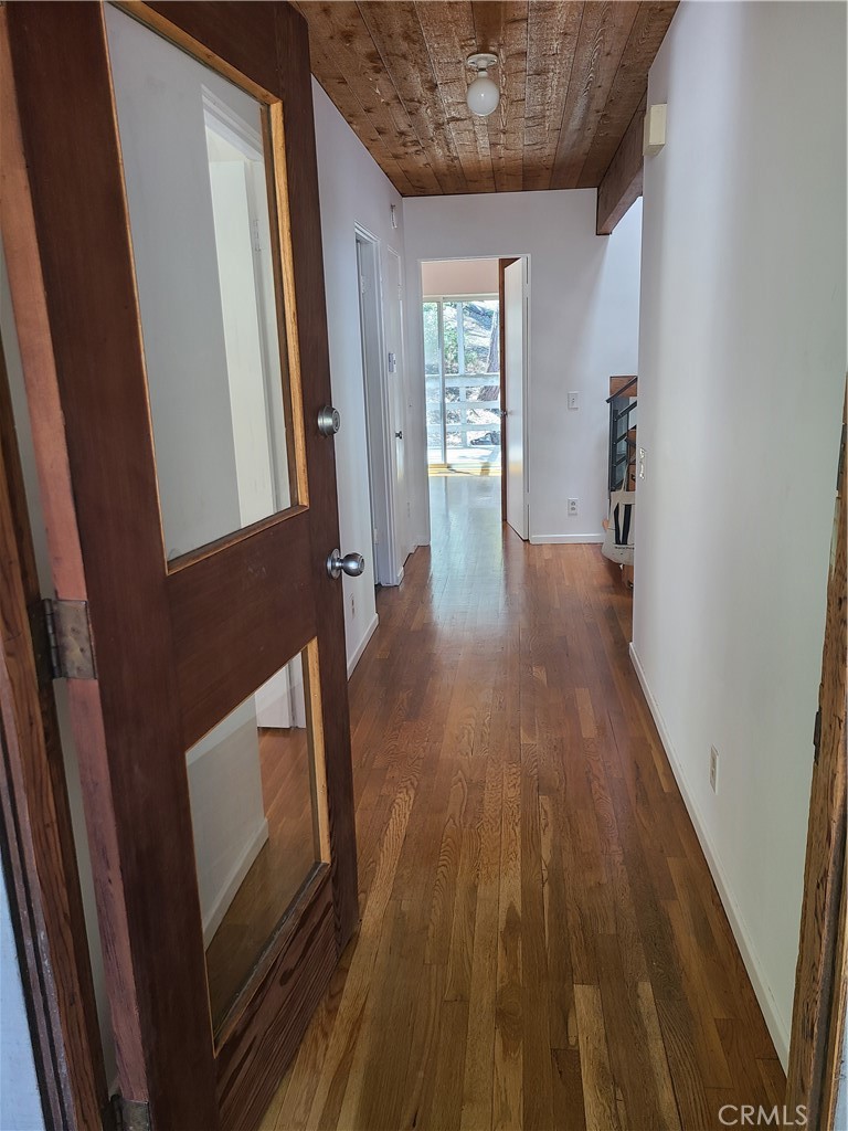 243 Amy Way Topanga, CA 90290 - Photo 8 of 31 a view of a hallway with wooden floor and stairs