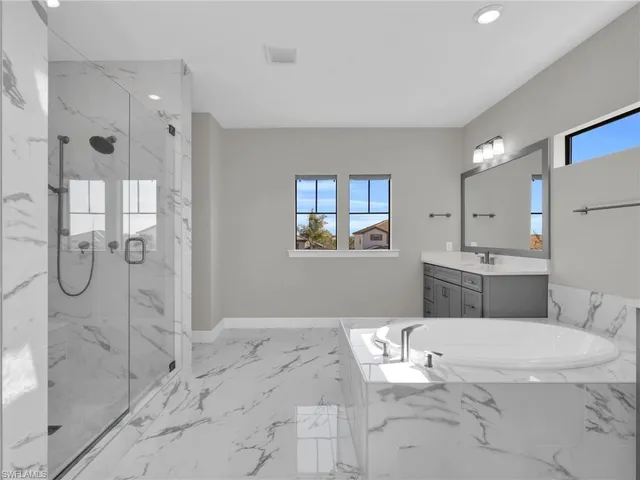a bathroom with a shower a sink and a mirror