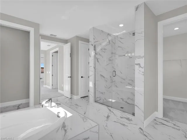 an empty room with a window and a ceiling fan