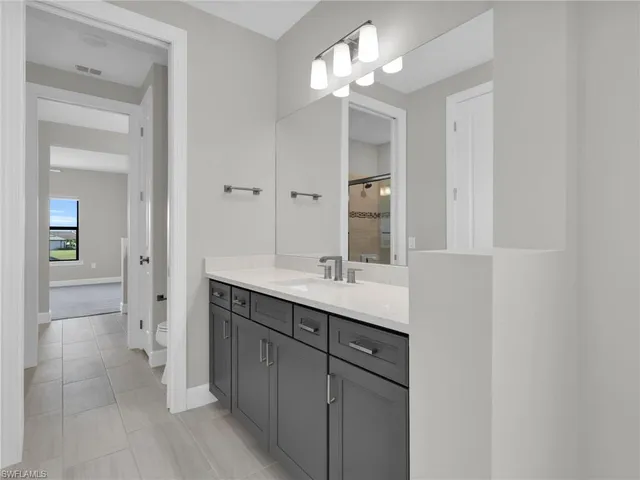 an empty room with windows and ceiling fan