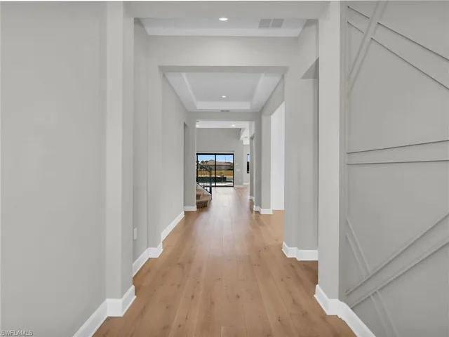 a view of a hallway view with wooden floor and staircase