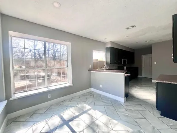 a view of room with a ceiling fan and window