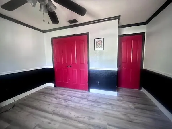 a view of a hallway with wooden floor